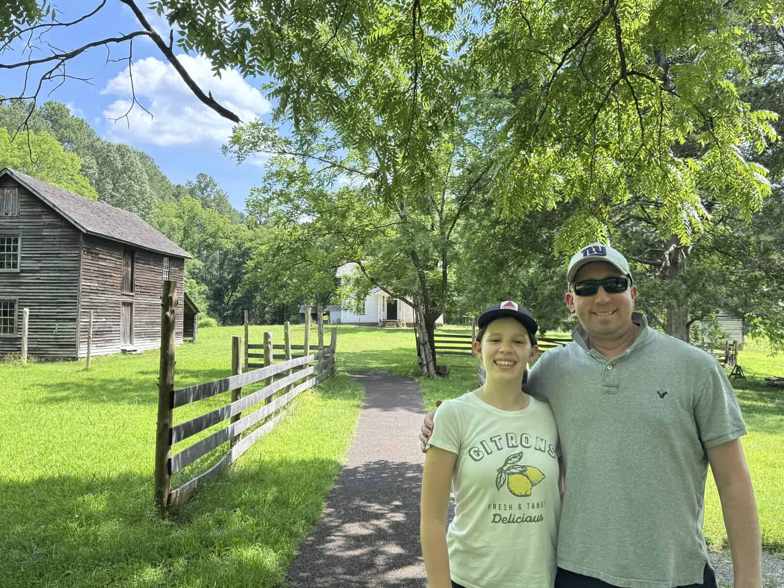 posing on the property of the Duke Homestead State Historic Site in Durham North Carolina