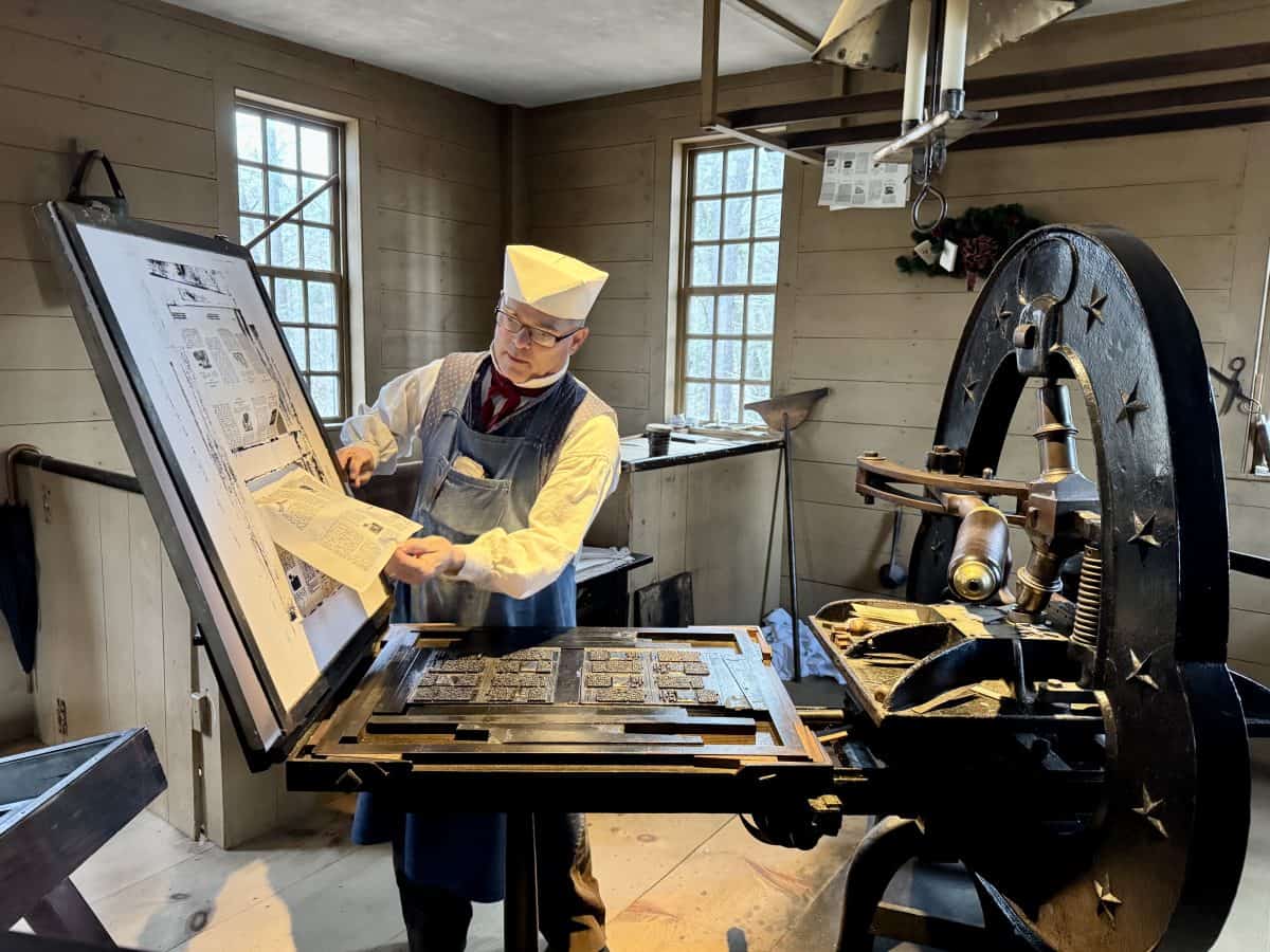 printing press demonstration at Christmas by Candlelight at Old Sturbridge Village in Sturbridge, MA