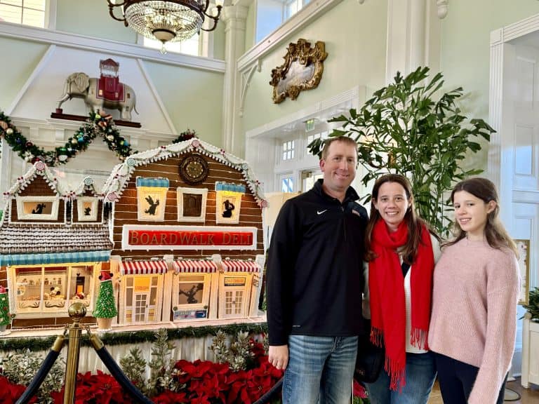 standing in front of the replica gingerbread deli at Disney's Boardwalk resort in Florida
