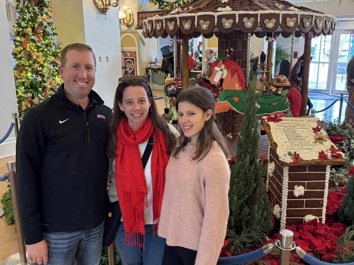 family in front of the gingerbread carousel at Disney's Beach Club resort in Florida