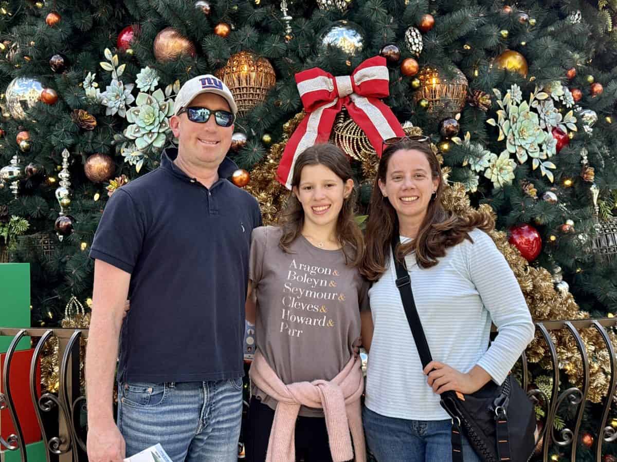 family in front of decorated tree at Disney Springs in Florida