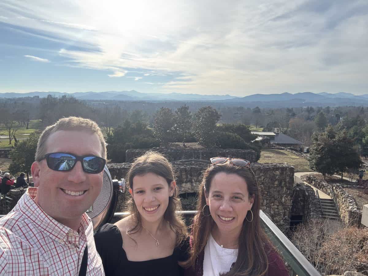 posing in front of the back side of the Omni Park Grove hotel in Asheville, NC