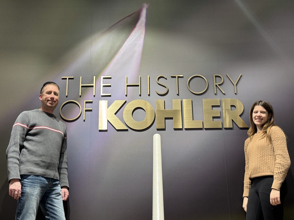 in front of the History Kohler sign at the History of Kohler museum at the Kohler Design Center in Kohler, Wisconsin