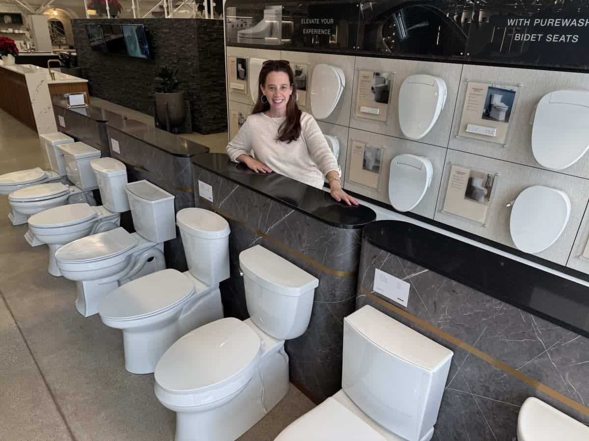 posing in front of toilet display at the Kohler Design Center in Kohler, Wisconsin
