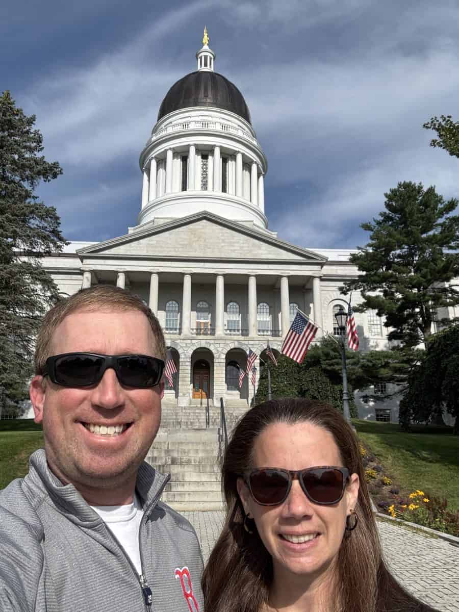 posing in front of the Maine State House in Augusta, Maine