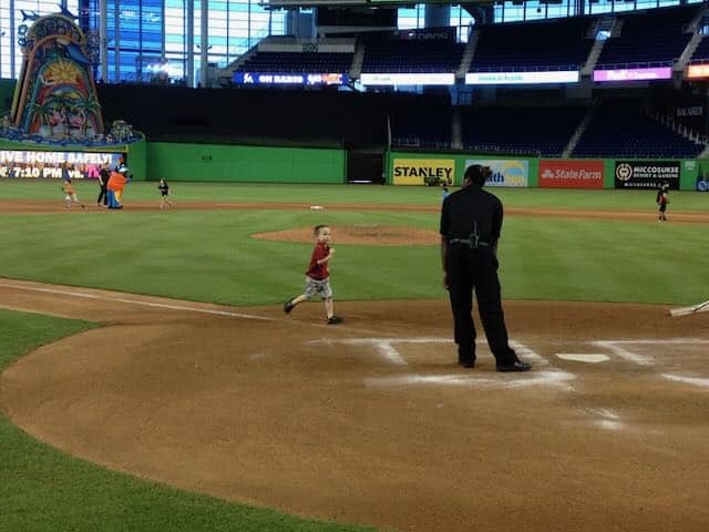 running to home plate at baseball park