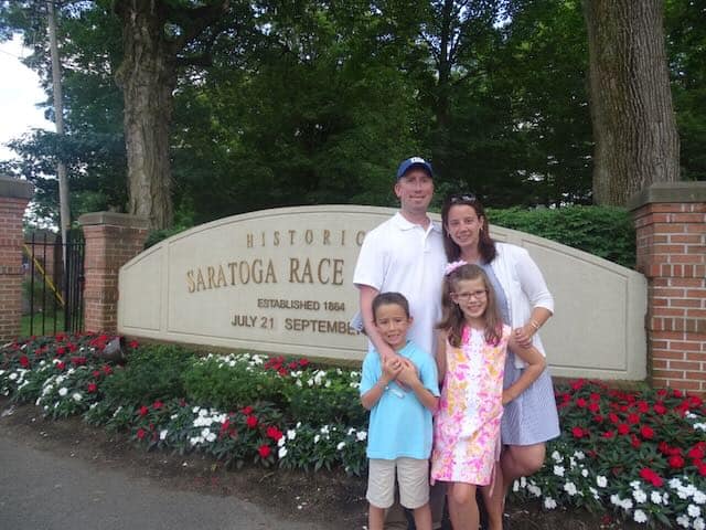 standing in front of Saratoga Race Track in Saratoga Springs, new York