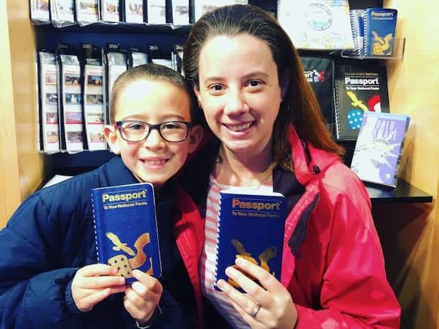 mother and son posing with National Park passport books