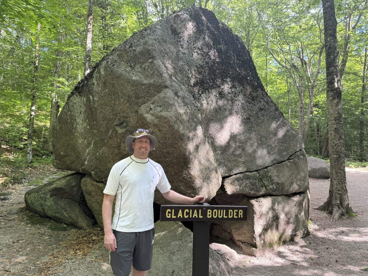 standing in front of Glacier Boulder at the Flume Gorge in Lincoln, NH