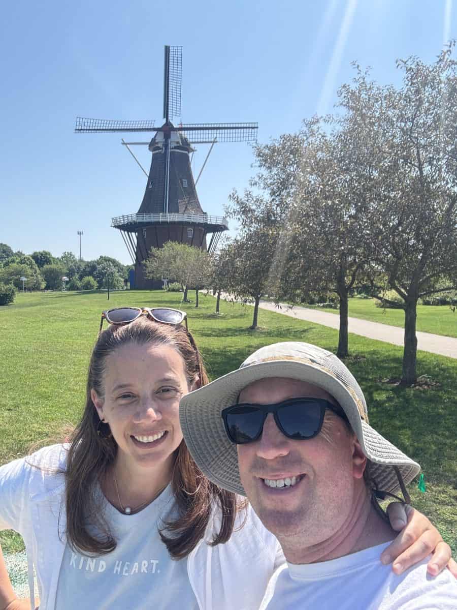 posing in front of the "swan" windmill at Windmill Gardens Village in Holland, Michigan