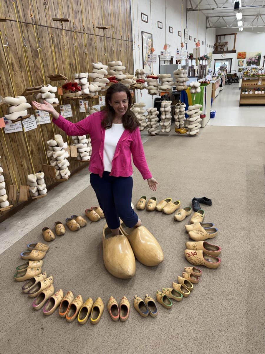 posing with a collection of Dutch shoes in Holland, MI