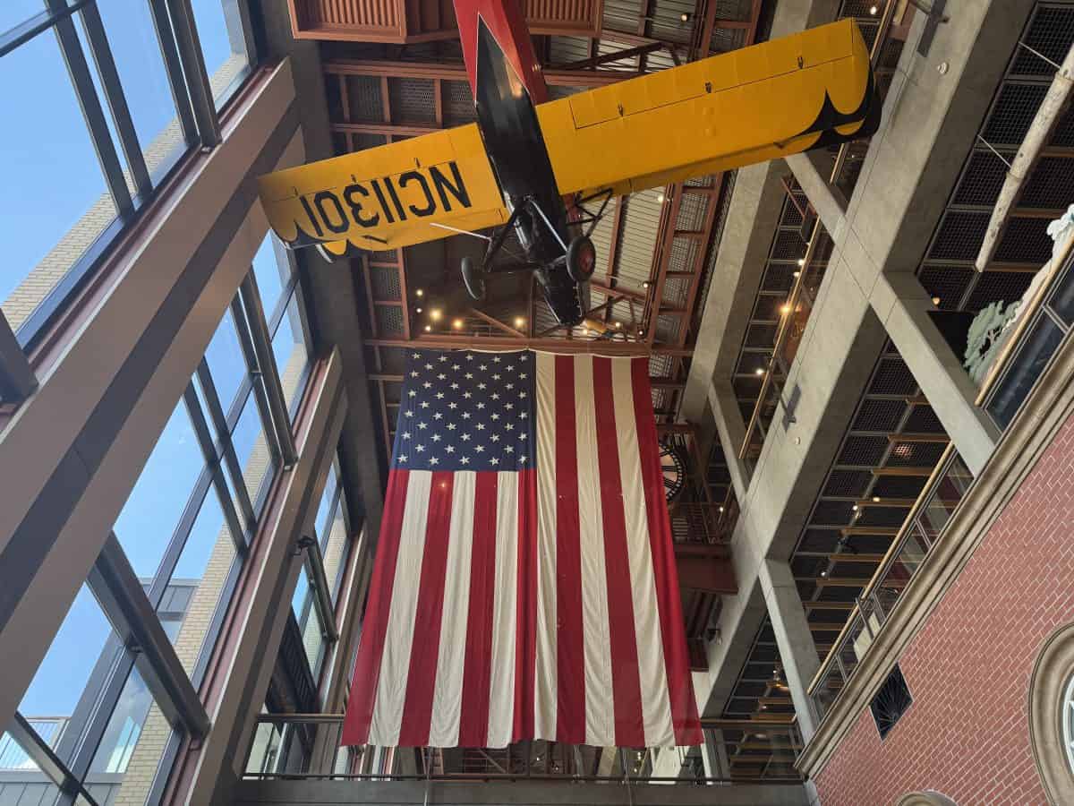 Galleria at the he Grand Rapids Public Museum in Michigan, displaying a bi plane and large American flag