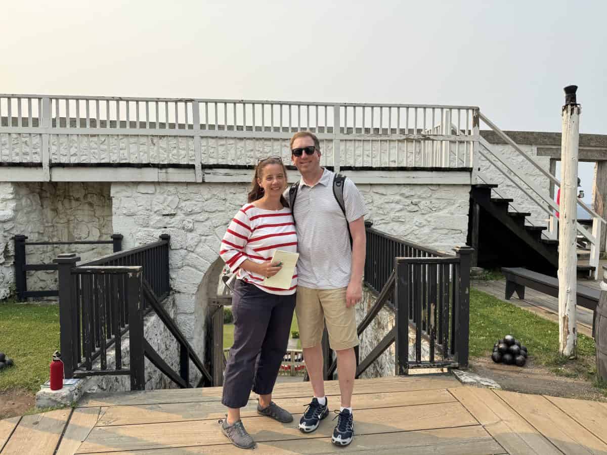 posing in front of a cannon at Fort Mackinac on Mackinac Island in Michigan