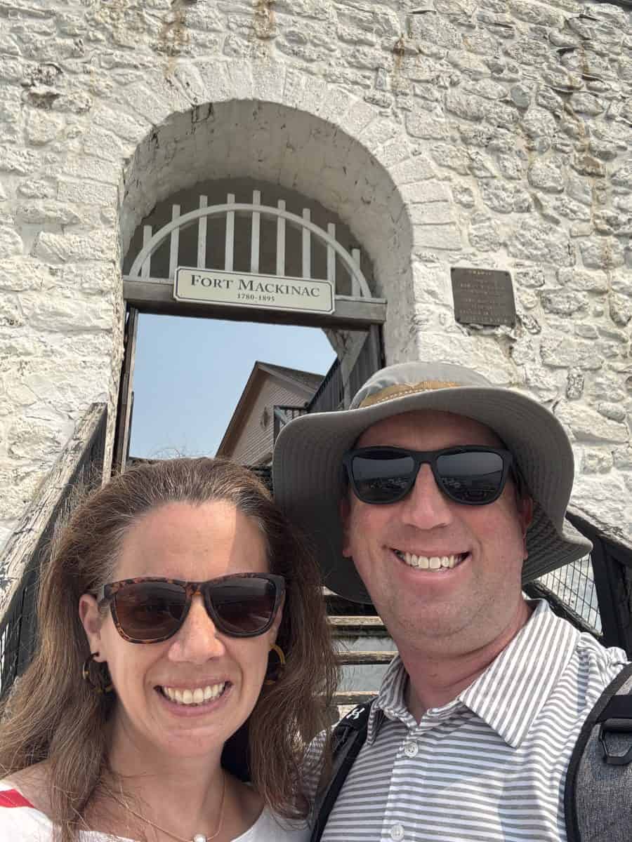posing in front of the entrance to Fort Mackinac on Mackinac Island in Michigan