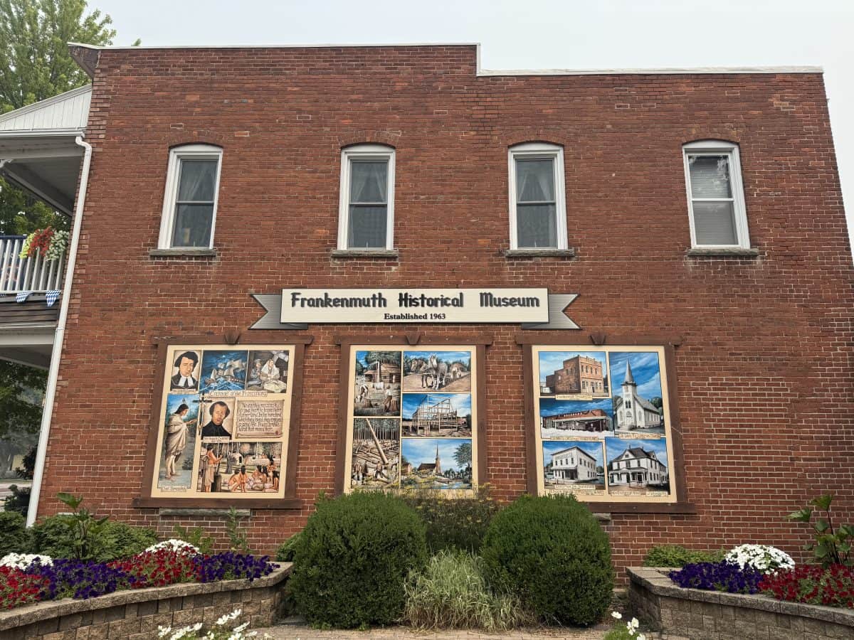 murals hanging on brick walls outside the entrance to the Frankenmuth History Museum in Frankenmuth MI